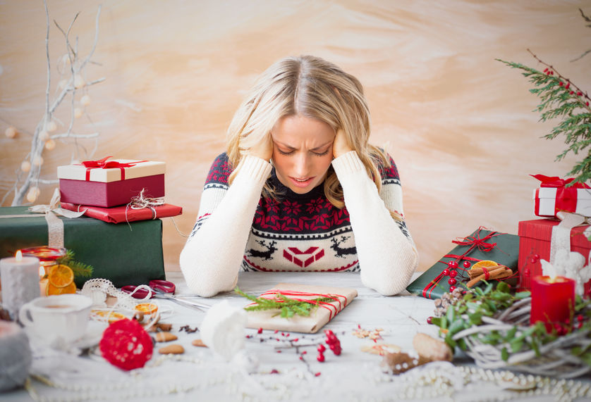 48971402 - woman depressed with christmas gift clutter